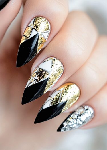 Exquisite geometric luxury nail art featuring black, gold, silver, and white designs.