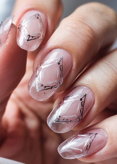 Elegant geometric nail art design with clear polish and intricate diamond-like patterns.