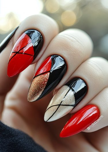 Stunning geometric nail design with red, black, and gold hues in a polished manicure.