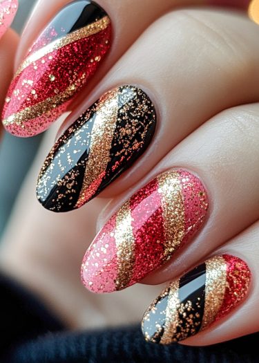 Glamorous nail art featuring red glitter, black polish, and gold accents for a stunning look.