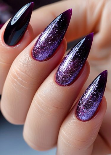 Stiletto nails featuring a captivating purple glitter ombre design, showcasing elegant nail art.