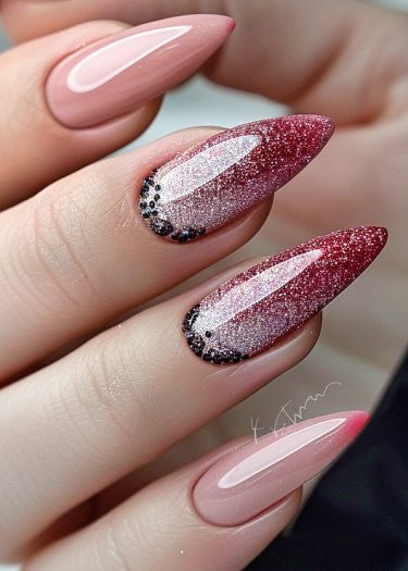 Elegant almond-shaped nails with glittery ombre design and pastel pink accents.