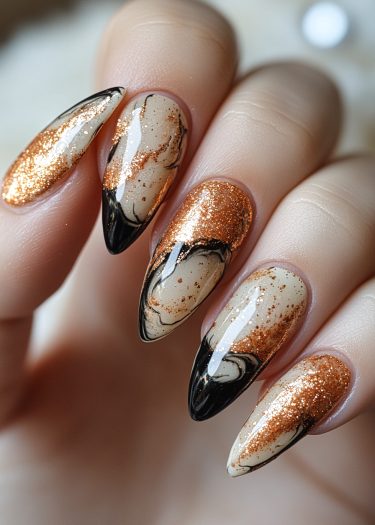 Stunning stiletto nails with copper glitter, black marbling, and elegant beige base design.