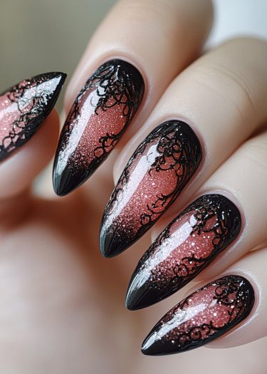 Elegant stiletto nail art with glittery pink gradient and intricate black lace design.