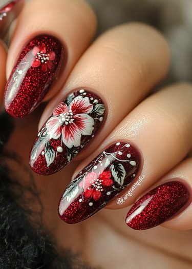 Exquisite burgundy nail art with floral designs and glittery finish for elegant style.