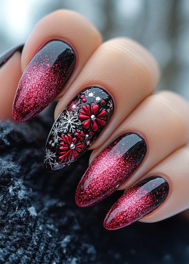 Stiletto nails with black glitter gradient and floral accents for stunning nail art design.