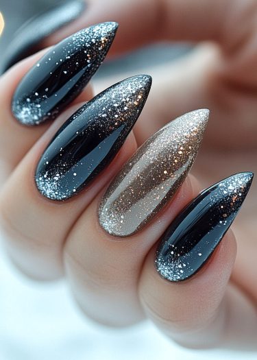 Elegant glossy black and silver ombre nails with sparkling glitter accents for a chic look.