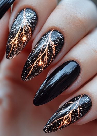 Stunning stiletto nails featuring glossy black, copper lightning designs, and sparkling glitter accents.