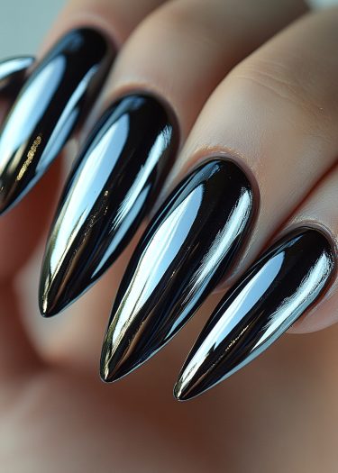 Glossy black almond stiletto nails exemplify luxury nail art and modern fashion elegance.