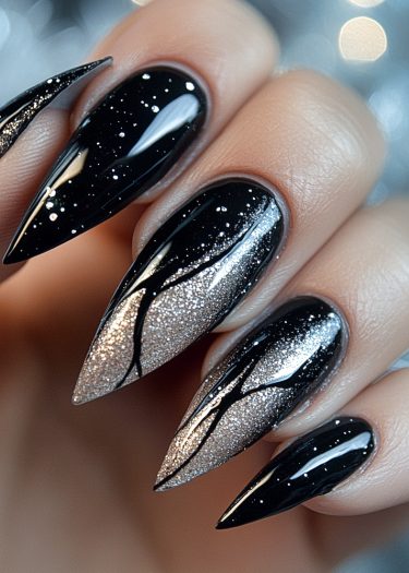 Elegant black stiletto nails with shimmering silver tips and intricate branch patterns.