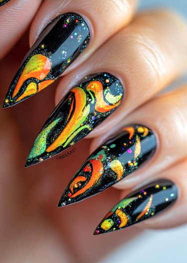 Vibrant glossy black stiletto nails with neon swirls and glitter for bold nail art.