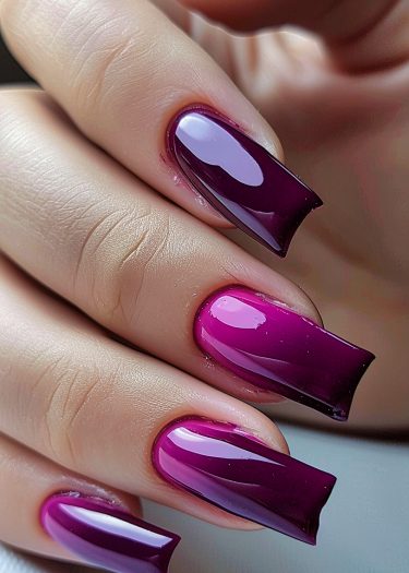 Stunning glossy burgundy and magenta gradient nails with a modern shape and flawless finish.