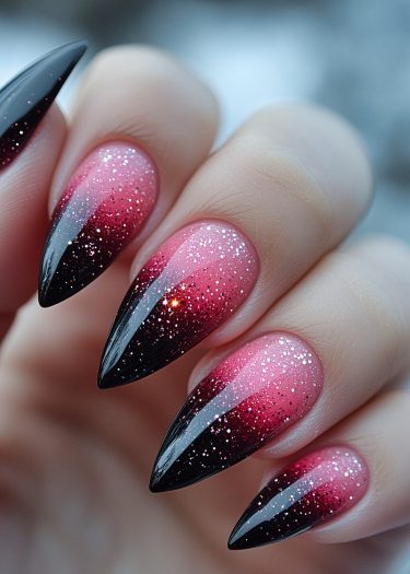 Elegant almond-shaped stiletto nails with black to raspberry pink gradient and sparkling finish.