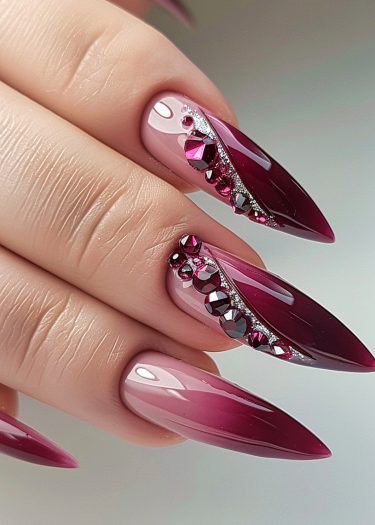 Stylish burgundy ombre nails with rhinestones for a glamorous, modern nail art look.