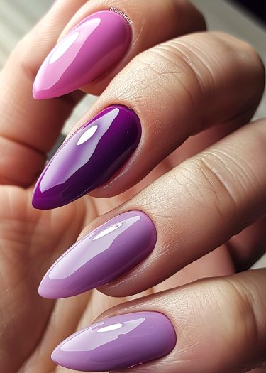 Elegant glossy nails with a pink to purple gradient manicure.