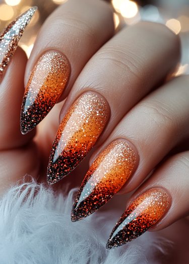 Elegant gold to black gradient nails with glitter for a glamorous autumn look.