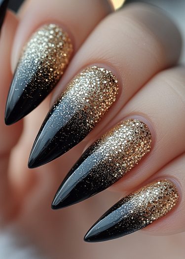 Elegant stiletto nails featuring a glamorous black and gold ombre gradient design.