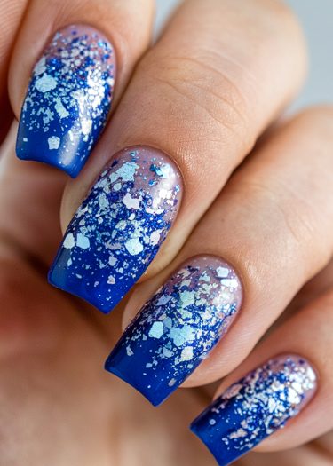 Elegant gradient blue glitter nails with sparkling details, perfect for any occasion.