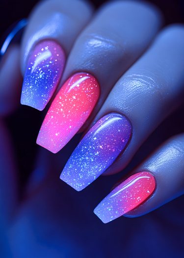 Stunning gradient glitter coffin nails in pink and purple with a glossy finish.