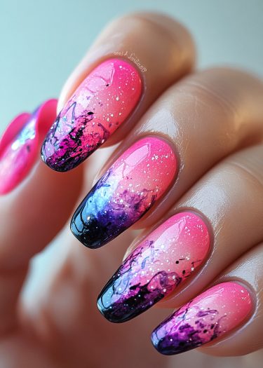 Vibrant gradient glitter nail art featuring intricate designs in pink, purple, and black.