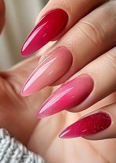 Elegant almond-shaped gradient red manicure with glossy finish and shimmering detail.