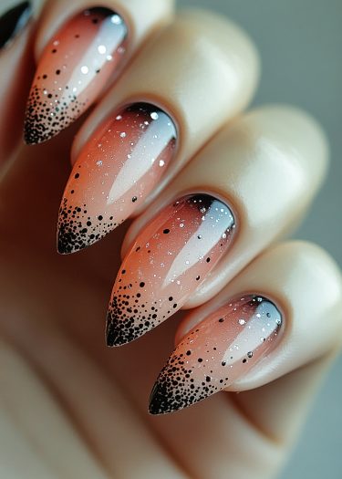 Stunning gradient stiletto nails with black, pink, and glitter for chic nail art.