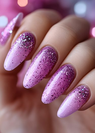 Stunning pink gradient glitter nails with a glossy finish and ombré effect for elegant nail art.