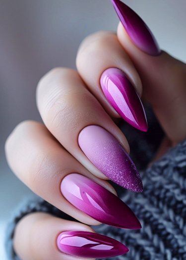 Elegant stiletto nails featuring a vibrant magenta-to-pink gradient with glitter accents.