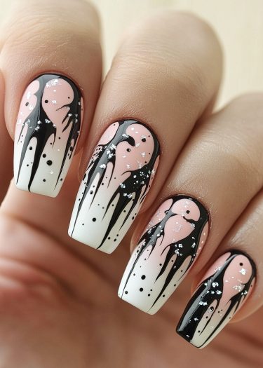 Elegant gradient pink and white nail art with striking black drips and silver glitter accents.