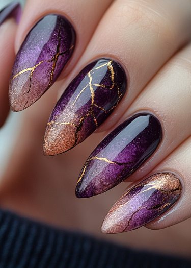 Stunning gradient purple and bronze nails with gold leaf art for elegant nail design inspiration.