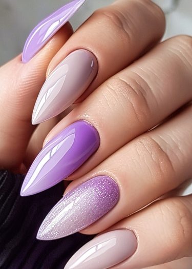 Intricate gradient purple nail design featuring elegant lavender and nude shades with stunning textures.