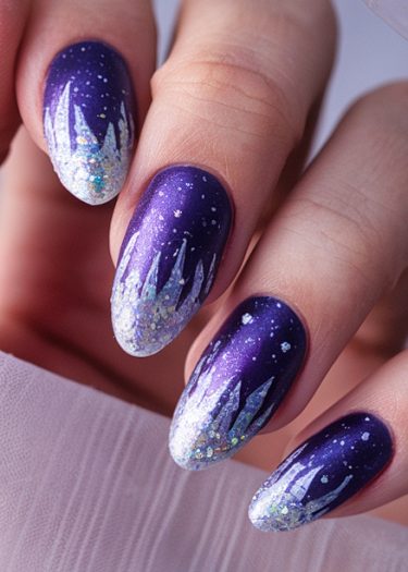 Elegant purple and white ombre nail art with celestial winter-themed designs and glitter accents.