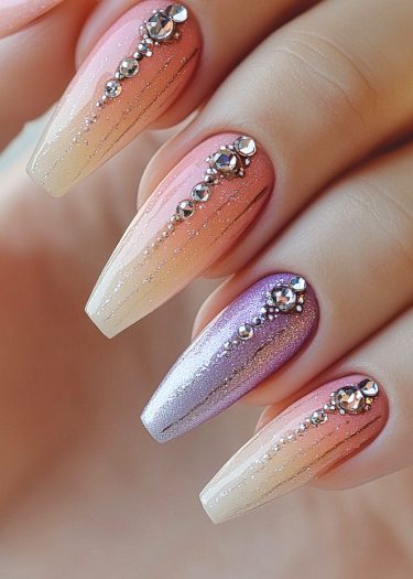 Elegant gradient nails with rhinestones and metallic lavender accent design for stunning nail art.