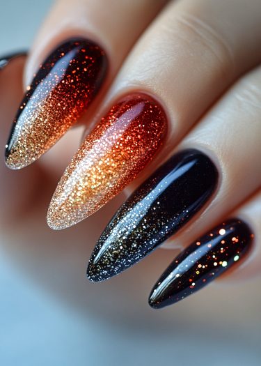 Elegant ombre stiletto nails with glitter, featuring warm and cool tones for a glamorous look.