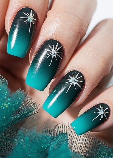 Ombre teal nail art with starburst designs and rhinestones for a chic manicure.