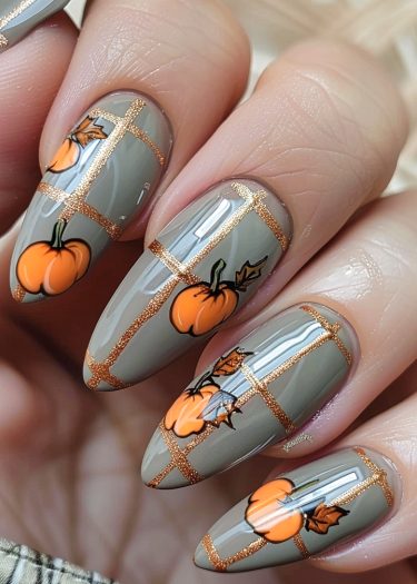 Elegant gray pumpkin nail art with gold glitter design for a chic autumn look.