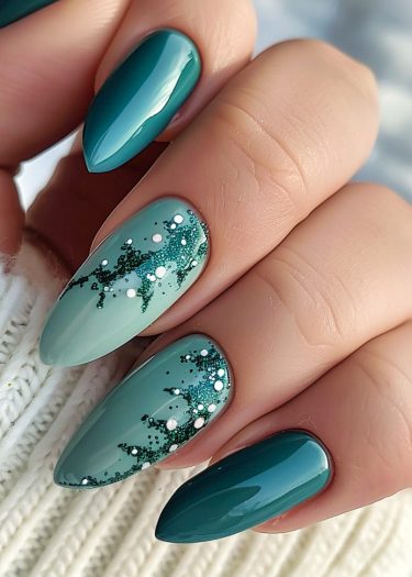 Elegant green almond manicure with intricate designs and glossy finish for a stunning look.