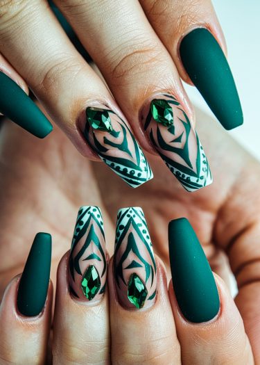 Elegant green geometric nail art with rhinestones on almond-shaped matte nails.