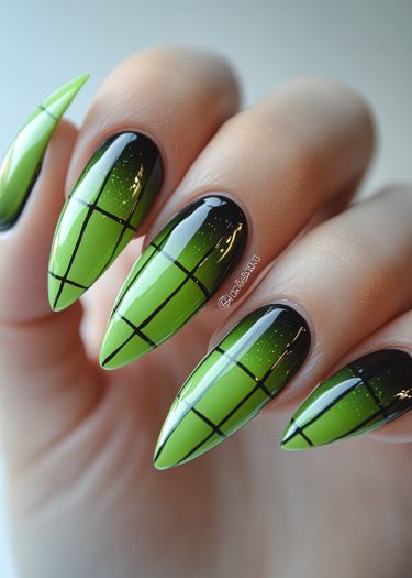 Stylish green gradient stiletto nails with a black grid design and sparkling glitter.