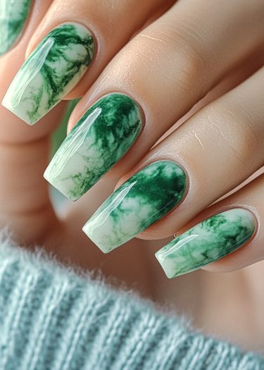 Elegant green marble nail art with intricate design and glossy finish.