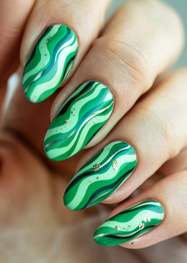 Vibrant green wave nail art with gold accents and unique designs on almond-shaped nails.