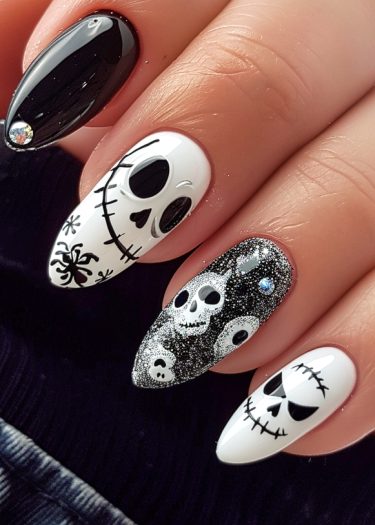 Halloween nail art with spooky designs, including skulls, spiders, and glittering details.