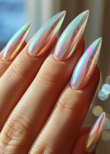 Impeccably manicured stiletto nails with a stunning holographic finish showcasing vibrant colors.