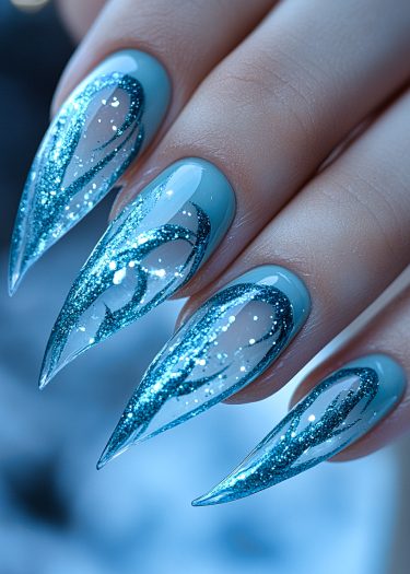 Gorgeous ice-blue stiletto nails with glitter and intricate designs for stunning nail art.