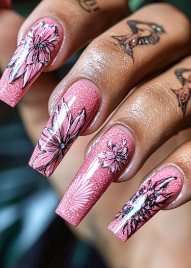 Elegant long coffin nails with floral designs and tattoos, showcasing intricate nail art craftsmanship.