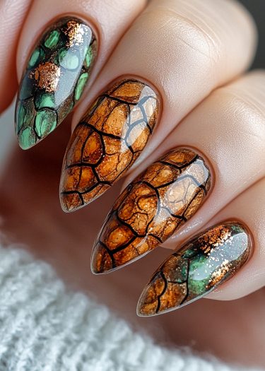 Elegant tortoiseshell nail art with earthy tones and gold accents, perfect for a stylish look.