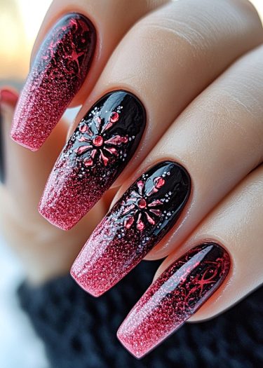 Stunning black and red ombre nail art with floral designs and glitter accents.