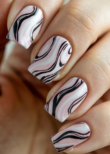 Elegant pastel pink nail art with marble patterns and bold black accents for a sophisticated look.