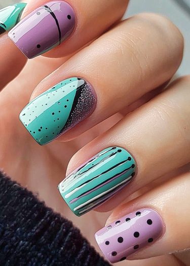 Vibrant teal and lavender nail art with polka dots and stripes for a stylish look.