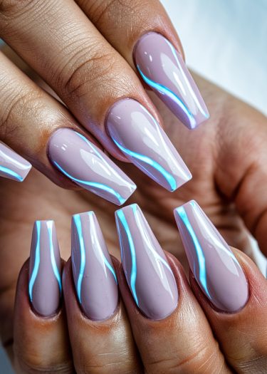 Elegant lilac coffin nails with glowing blue design, showcasing modern nail art trends.